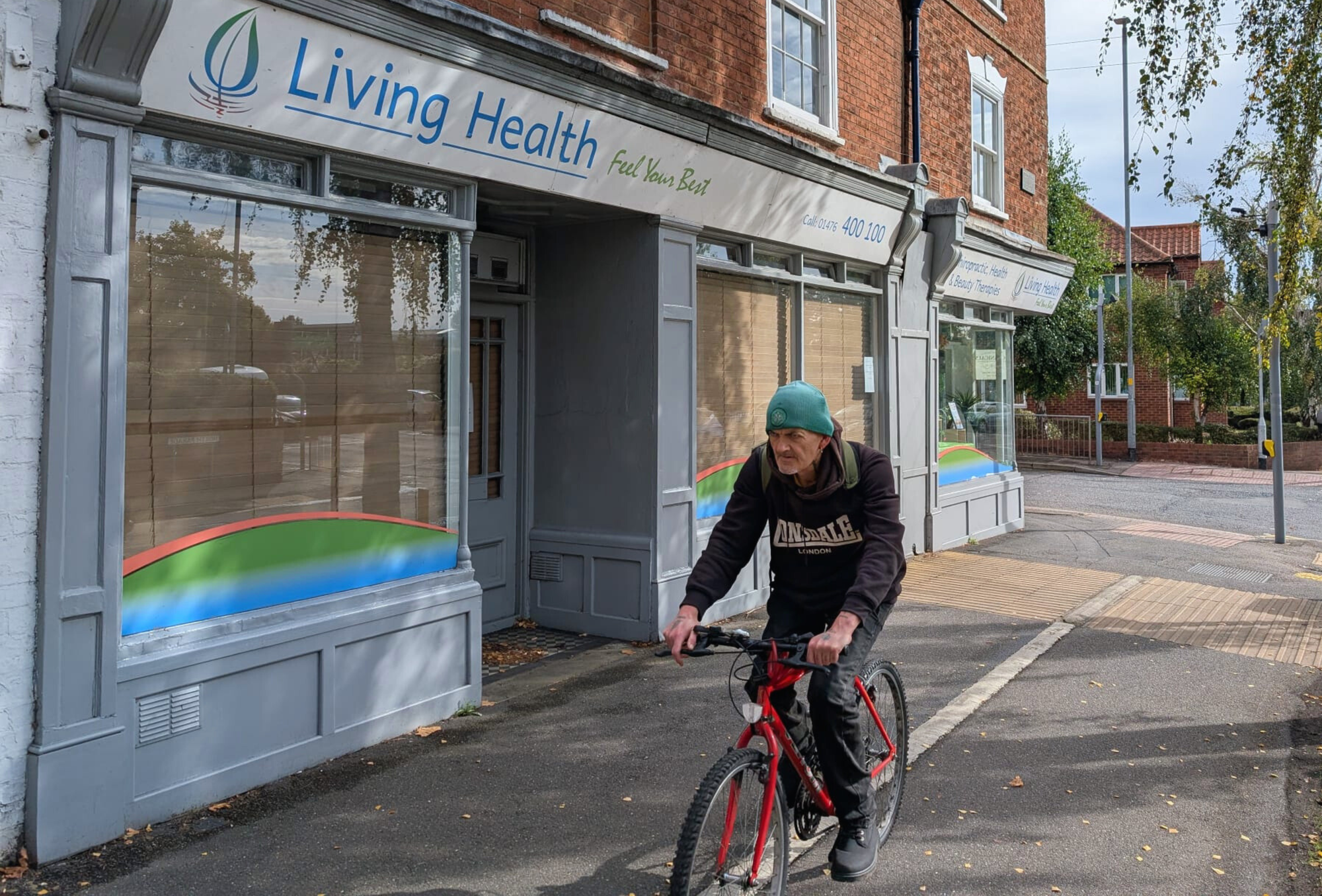 A man cycles past the wellness centre that replaced Thatcher's home (Dispatch)