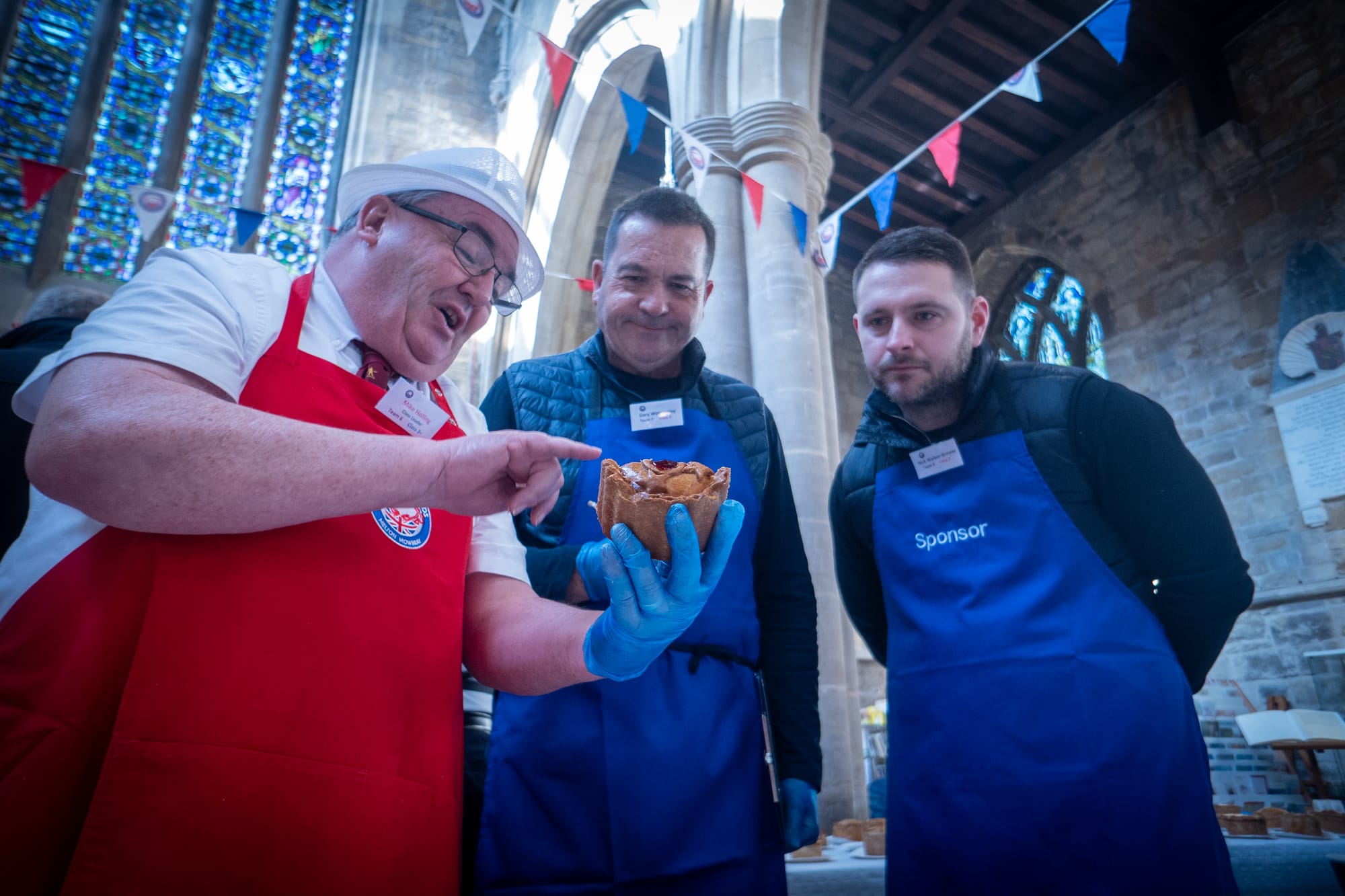 A judge inspects a pie at the British Pie Awards