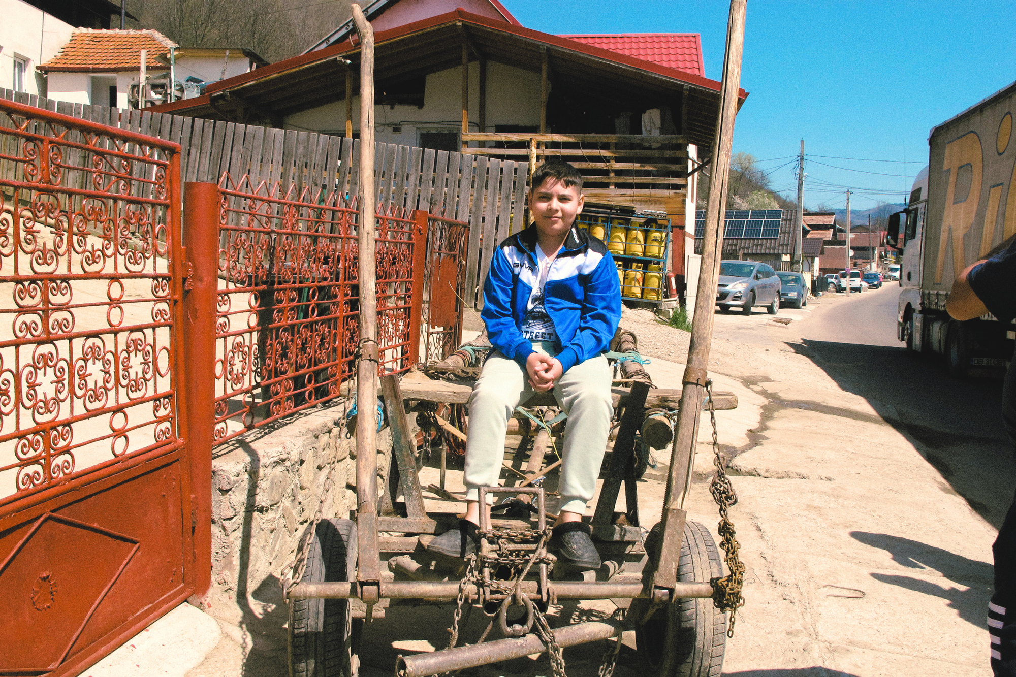 Andrei sits atop a wagon in Glod (Fonie Mitsopoulou)