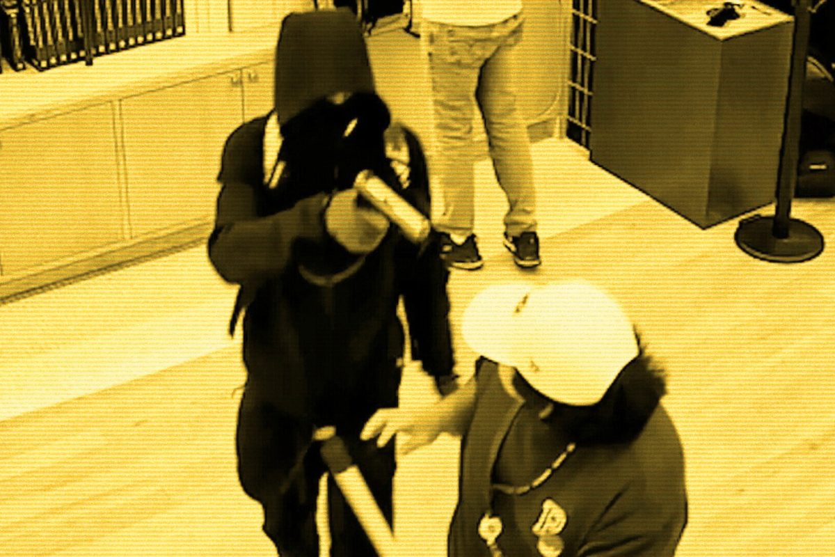 An armed robber holds up a Pokémon trading shop in New York in January 2026 (Supplied)