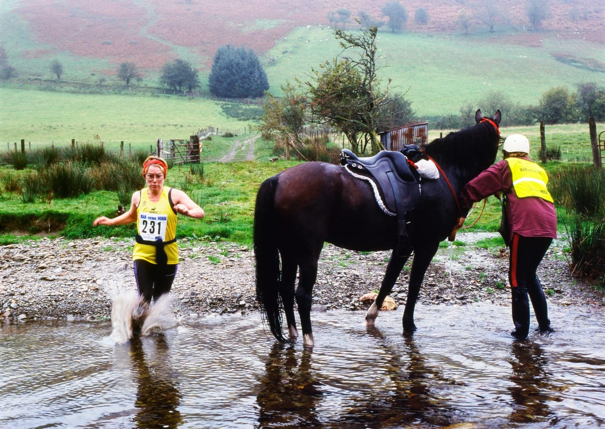A contestant overtakes a resting horse in the Man v Horse marathon (Kathy deWitt)